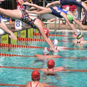 Girl diving into the pool at a gala