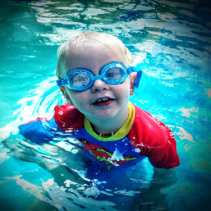 Toddler in the swimming pool with goggles