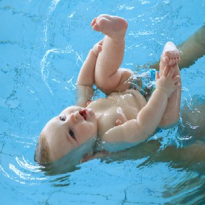 Baby on its back while swimming